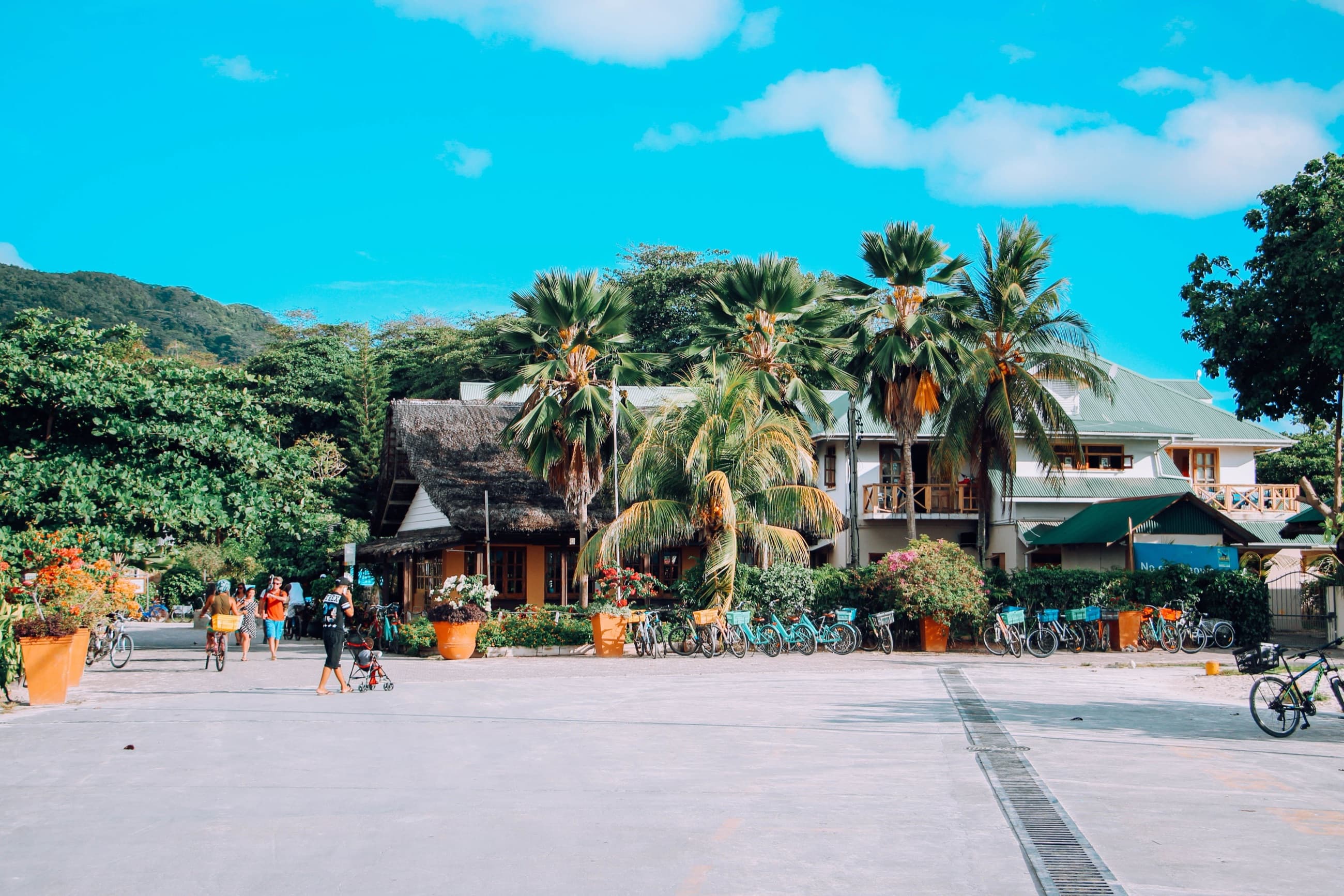 Bicycles parked outside a thatched-roof building in La Digue's village of La Passe