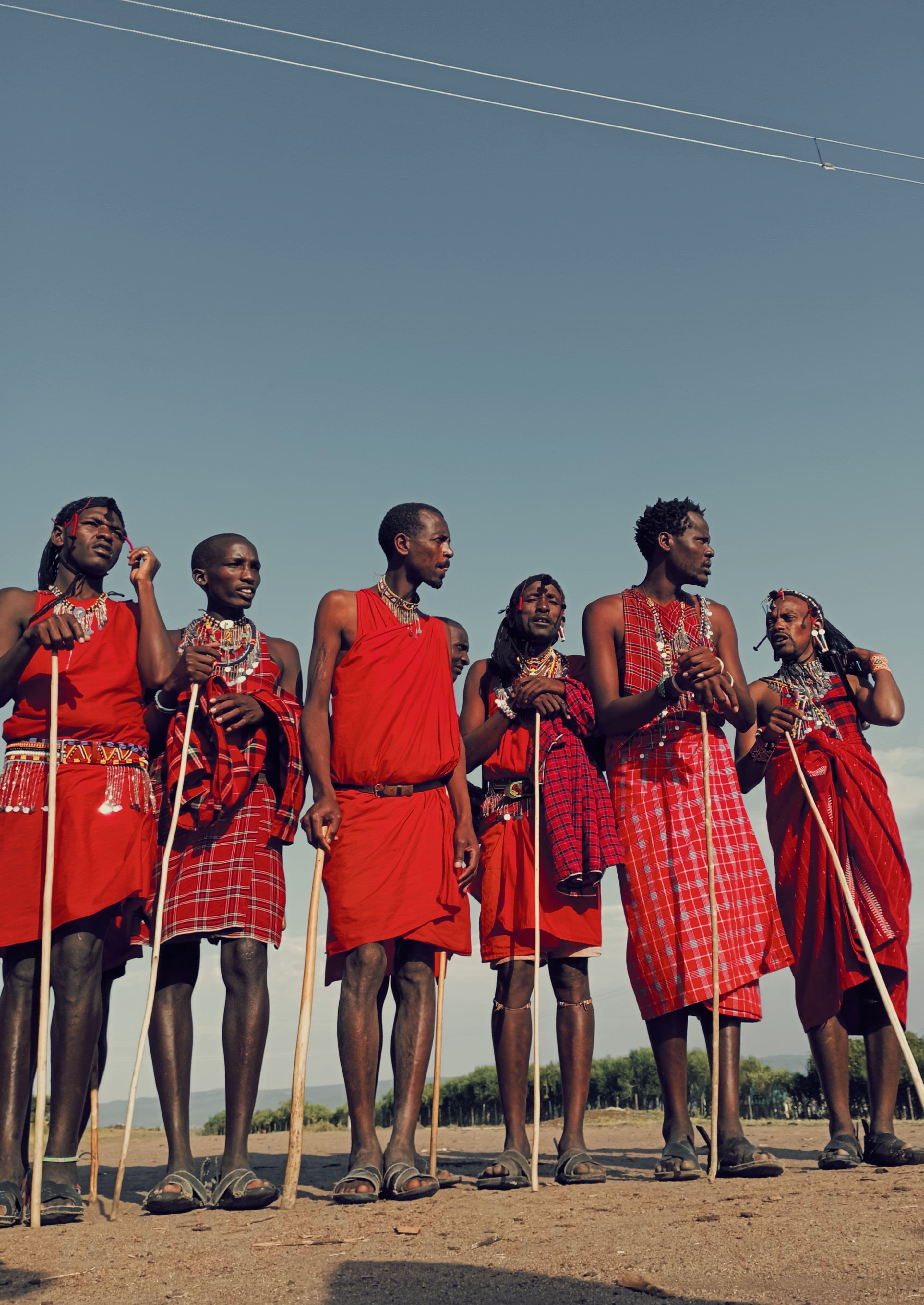 A group of Maasai warriors in traditional red shuka standing together