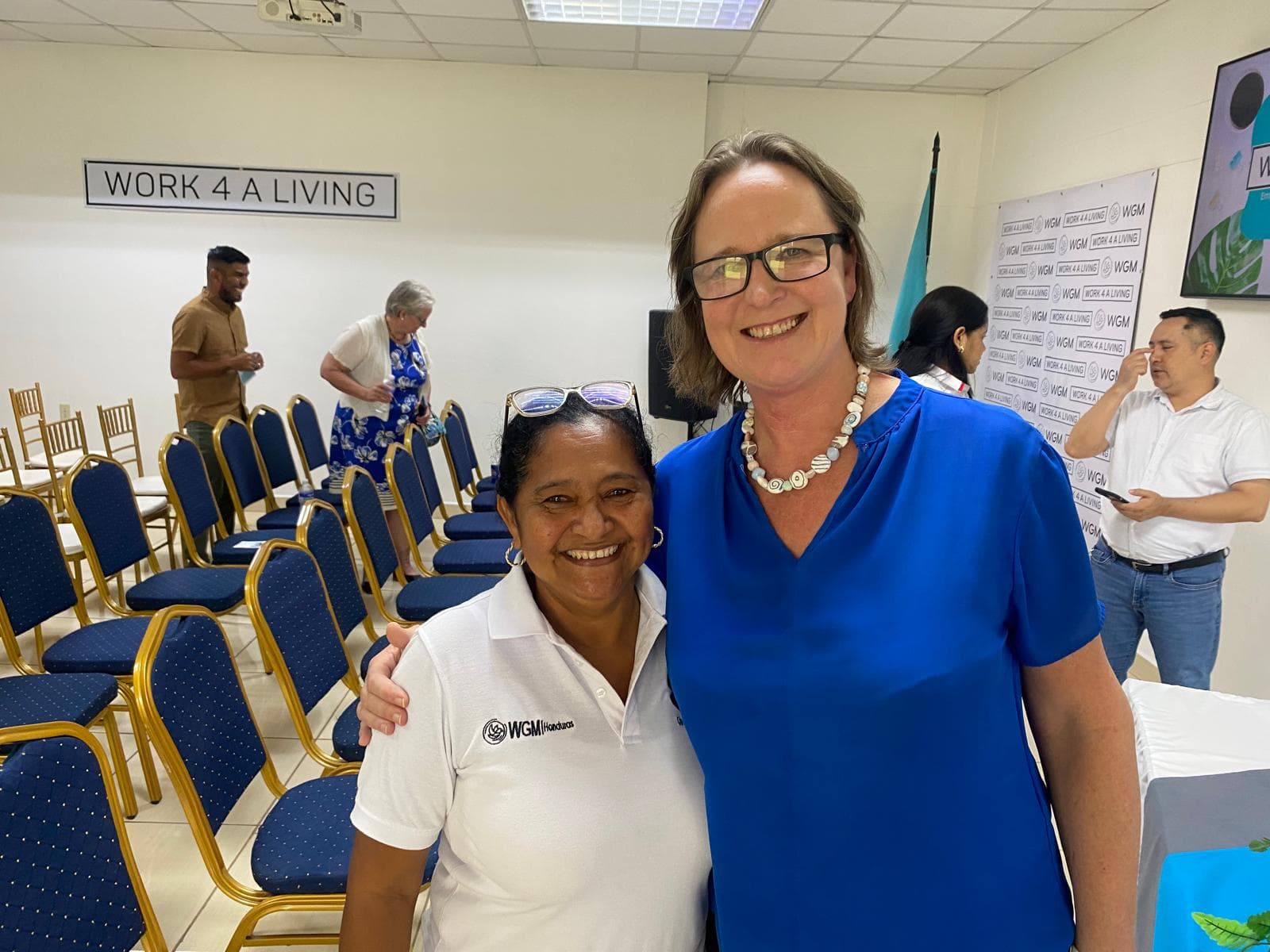 Ena Richards embracing a WORK 4 A LIVING graduate at a training centre in Honduras