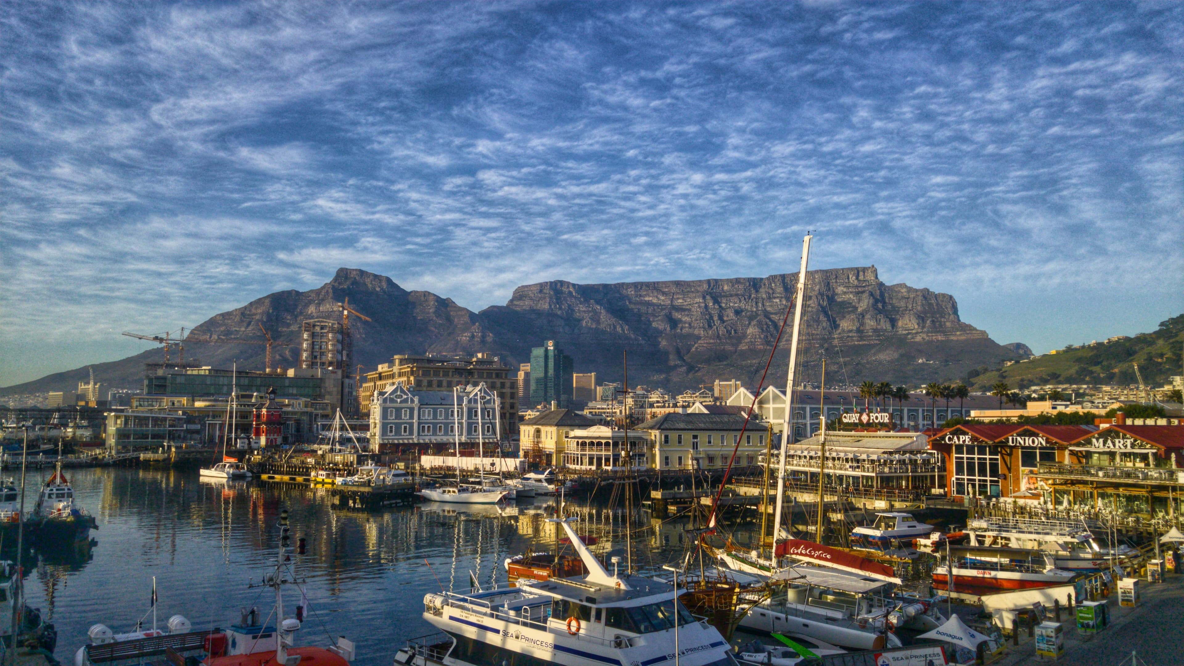Boats moored at the V&A Waterfront with Table Mountain rising behind