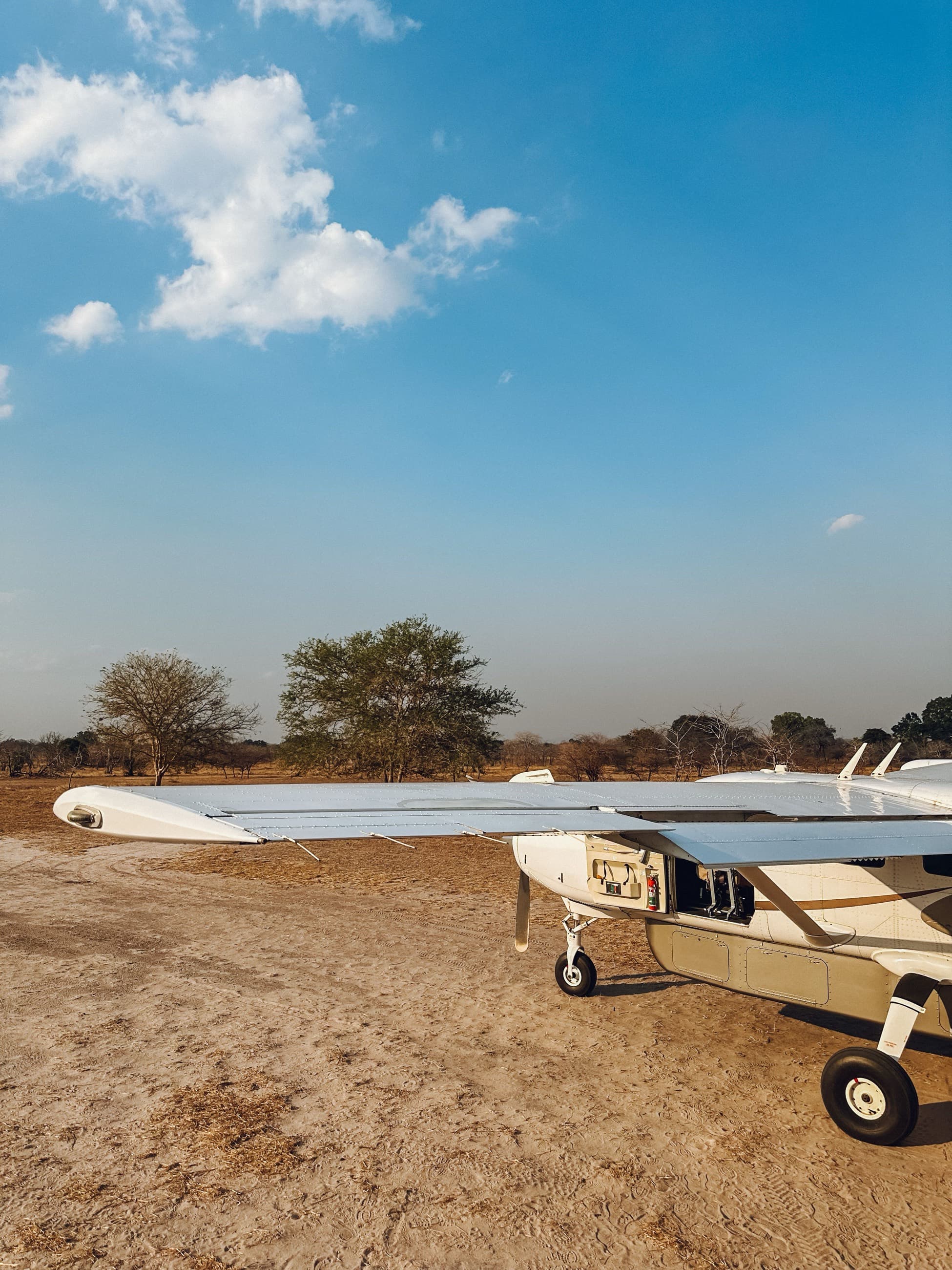 A light safari aircraft parked on a remote bush airstrip
